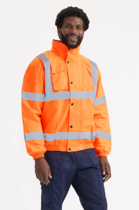 A man wearing a bright orange high-visibility work jacket with reflective silver stripes and navy blue trousers, photographed against a clean white studio background.