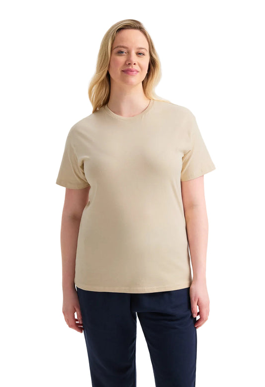 Woman wearing a beige t-shirt and navy pants on a white background