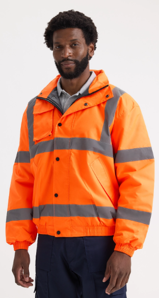 A man wearing a bright orange high-visibility work jacket with reflective gray stripes, shown from the waist up against a plain light gray studio background.
